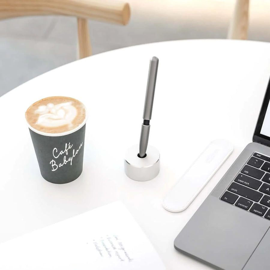 Stilform Aluminium Base holding a pen on a minimalist desk setup