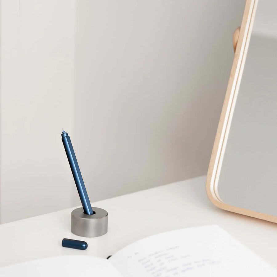 Stilform Titanium Base holding a Stilform pen, demonstrating its functional elegance
